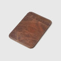 Brown leather wallet on a light gray background with 'Obroi' branding.
