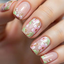 Nails with floral design and gold accents on a blurred background, Obroi