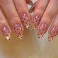 Nails with red heart designs on a neutral background, Obroi
