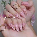 Close-up of hands with pink and gold nail art and matching rings, Obroi