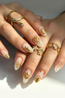 Full set of 24‑piece medium almond nails‑milky white pearl base with metallic gold embossed floral pattern