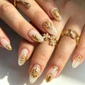 Full set of 24‑piece medium almond nails‑milky white pearl base with metallic gold embossed floral pattern