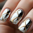 Close-up of nails with gold and silver nail art on a neutral background, Obroi