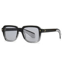 Black sunglasses with a clear lens on a white background, featuring the brand 'SHAUNA'.