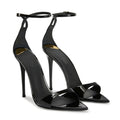 Black high-heeled shoes with ankle straps on a white background, Obroi