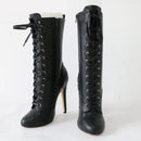 Pair of black lace-up high-heeled boots on a white background, Obroi