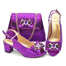 Purple high-heeled shoes and matching handbag with decorative elements on a white background, Obroi