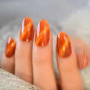 Close-up of a hand with orange nail polish on a blurred background, Obroi