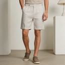 Person wearing light-colored shorts and brown shoes in a minimalistic setting, Obroi