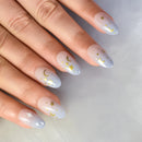 Nails with star and moon designs on a light background, Obroi
