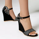 Black wedge sandals with rhinestone details on a white background, Obroi