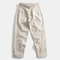 Beige pants with a belt on a light gray background, Obroi