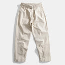 Beige pants with a belt on a light gray background, Obroi