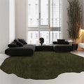 Modern living room with a dark green rug, black sofa, and large windows, Obroi