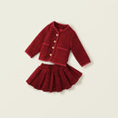 Red knitted jacket and skirt set on a beige background, Obroi