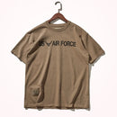 Brown t-shirt with 'US Air Force' text on a hanger against a white background, Obroi
