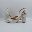 White wedding shoes with floral embellishments on a light gray background, Obroi