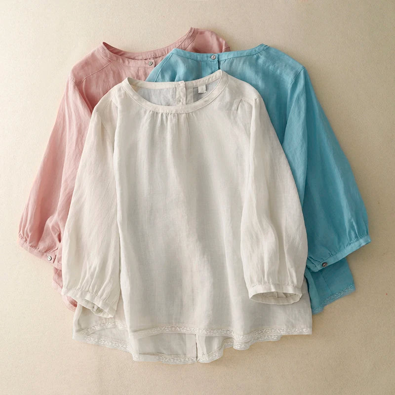 Three long-sleeve shirts in white, pink, and blue on a beige background