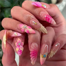 Close-up of hands with pink and clear floral nail art, Obroi