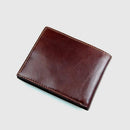 Brown leather wallet on a light gray background, Obroi