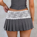 Gray polka dot skirt with white lace trim worn by a person on a neutral , Obroibackground