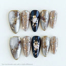 Set of decorative nails with a mix of silver, gold, and black on a white background, Obroi