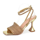Gold high-heeled sandal with clear strap on a white background, Obroi