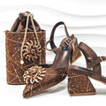 Brown studded high-heeled shoes and matching handbag on a white background, Obroi