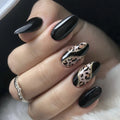 Hand with black nail polish and leopard print design on a neutral background, Obroi
