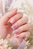 A split comparison of two nail polish looks labeled 'Obroi' on the left and 'Bold Sparkle' on the right, showing manicured fingernails with sheer pink base and glittery star details, set against a soft floral background, Obroi