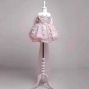 Floral dress on a mannequin with a white stand against a gray background, Obroi