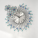 Decorative wall clock with floral design and blue accents on a white background, Obroi
