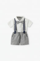 A baby boy's formal outfit consisting of a white short-sleeve button-up shirt, gray textured suspenders with navy blue straps, a gray bow tie, and matching gray shorts, displayed on a clean white background, Obroi