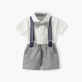 A baby boy's formal outfit consisting of a white short-sleeve button-up shirt, gray textured suspenders with navy blue straps, a gray bow tie, and matching gray shorts, displayed on a clean white background, Obroi