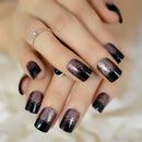 Close-up of a hand with black and metallic glitter nail polish on a blurred background, Obroi