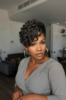 Woman with styled hair wearing large hoop earrings indoors, Obroi