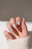 Hand with iridescent nail polish on a neutral background, Obroi