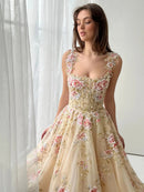 Woman wearing a floral dress in front of a white curtain, Obroi
