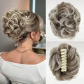 A collage showing a curly hairpiece/wig extension: a woman on the left wears it styled in an updo, and two close-up views on the right show the full bun shape and the cream claw clip attachment. The hair is a cool ash blonde with gray undertones, Obroi