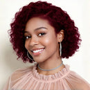 Woman with vibrant red hair wearing a pink top against a white background, Obroi