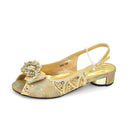 Gold glittery sandal with decorative bow on a white background, Obroi