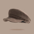 Brown newsboy cap on a beige background, Obroi