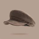 Brown newsboy cap on a beige background, Obroi