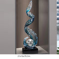 Obroi decorative glass sculpture with wavy design on a stand in a room setting.