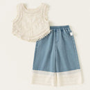 White sleeveless top with lace details and blue denim shorts with lace trim on a white background, Obroi