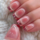 Close-up of a hand with pink and gold glittery nail polish on a soft white background, Obroi