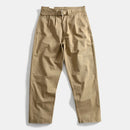 Beige pants with a belt on a light gray background, Obroi