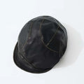 Black leather cap on a white background, Obroi