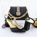 Black high-heeled shoes and handbag with gold accents on a white background, Obroi