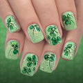 Green nail art with shamrock designs on a matching green background, Obroi